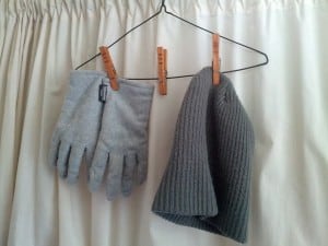 Clothes pins holding drying gloves